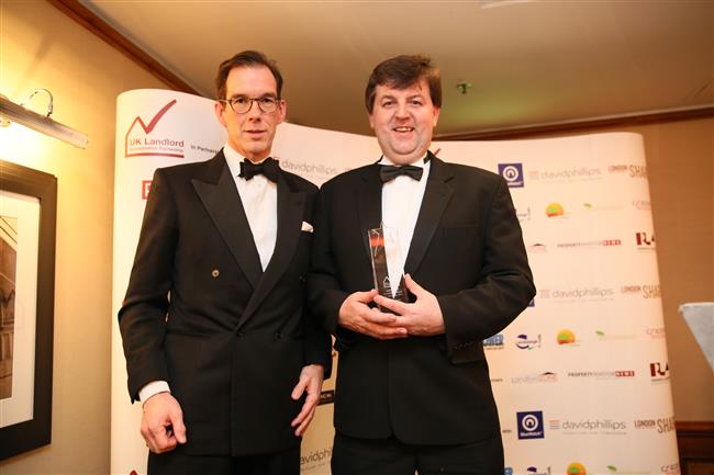 Mark Meehan (Assistant Director of Housing, London Borough of Ealing) accepts award presented by Platinum Sponsor David Phillips (Nicholas Gill, CEO)