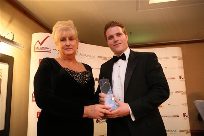 Mr Adam Goff from Capital Living wins Best Portfolio Landlord (20+ properties) presented by Maxine Goggins (CEO, Weir Housing Limited)