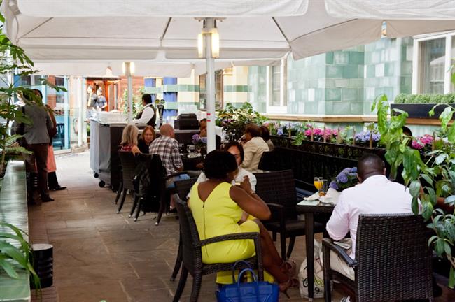 Guests in the court yard sitting area near the bar