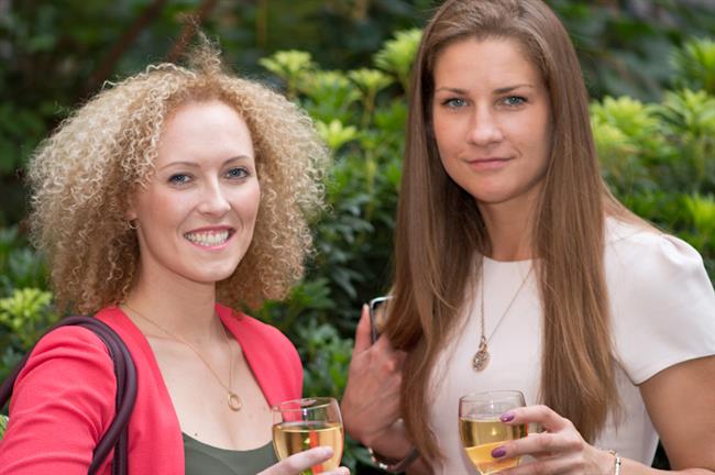 Ladies with their drinks, smile for the camera